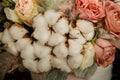 Top view macro on elegant bouquet of white cotton flowers and assorted roses