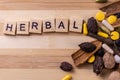 Top view macro shot of herbal pills and tablets arranged with spices on a red stone. Unani medicines concept Royalty Free Stock Photo