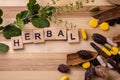 Top view macro shot of herbal pills and tablets arranged with spices on a red stone. Unani medicines concept Royalty Free Stock Photo