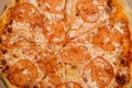top view macro of whole sliced pizza with tomato slices