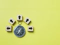 Top view magnetic compass with multiple arrow icons on wooden cubes.