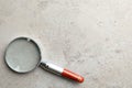 Top view of magnifier glass on light grey stone background, space for text. Find keywords concept Royalty Free Stock Photo