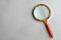 Top view of magnifier glass on grey stone background, space for text. Find keywords concept Royalty Free Stock Photo