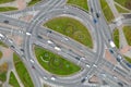 Top view of a major road junction in the city during the day. A large busy roundabout. Urban traffic and infrastructure. Green Royalty Free Stock Photo