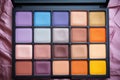 top view of makeup palette with colorful eyeshadows