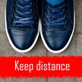 Top view on male blue sneakers standing on the pavement in front of the red line.Keep distance concept.Social isolation and Royalty Free Stock Photo