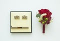 Top view of male cufflinks and red boutonniere