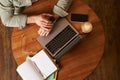 Top view of male hands, man checking time or message on his digital watch, sitting in a cafe with laptop, mobile phone Royalty Free Stock Photo