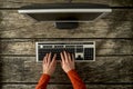 Top view of male hands typing on personal computer keyboard