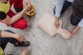 Top view of male instructor showing first medical aid on doll during training course indoors