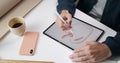 Top view of male web designer creating sketch of apple on digital tablet.Talanted guy using pad and stylus while sitting