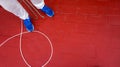 Top view of a man in blue sneakers standing on the red floor Royalty Free Stock Photo