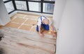 Man working on laminate flooring installation in apartment. Royalty Free Stock Photo