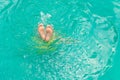 Top view of a man diving in swimming pool with feet up Royalty Free Stock Photo