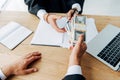 View man giving bribe to judge in handcuffs near laptop Royalty Free Stock Photo