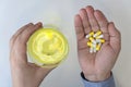 top view of man hand holding pills and glass of water on white background top view Royalty Free Stock Photo