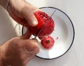 Top view of man hands cutting pomegranate with a knife Royalty Free Stock Photo