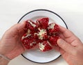Top view of man hands holding a partially peeled pomegranate Royalty Free Stock Photo
