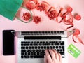 Man hands on laptop on festive pink background