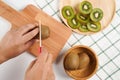 Top view man hands slice fresh Kiwi fruit on chopping board Royalty Free Stock Photo