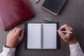 Top view of man hands writing on empty notebook with pen in office. Royalty Free Stock Photo