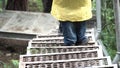 Top view of a man hiker going down the metal stairs in the forest. Stock footage. Close up of traveler legs on the path Royalty Free Stock Photo