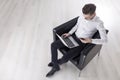 Top view of man with laptop in armchair Royalty Free Stock Photo