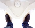Top view of a man legs in front of urinal in men toilet Royalty Free Stock Photo
