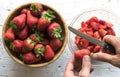 Top view of man`s hands preparing fruit salad with strawberries Royalty Free Stock Photo