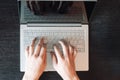 Top view of man`s hands typing on laptop keyboard Royalty Free Stock Photo