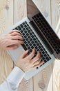 Top view of man`s hands typing on laptop in sunny day. Coworking or working at home concept image Royalty Free Stock Photo