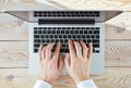 Top view of man`s hands typing on laptop in sunny day. Coworking or working at home concept image Royalty Free Stock Photo