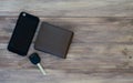 Top view of man set. Wallet, car key and smartphone on wooden background. Top view with copy space Royalty Free Stock Photo