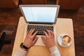 Top view of man sitting in cafe while using laptop Royalty Free Stock Photo