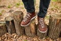 Top view man standing with hiking mountain boots on autumn leaves and wood background Royalty Free Stock Photo