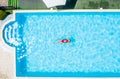 Top view of a man swimming in a swimming pool on warm and sunny summer day Royalty Free Stock Photo