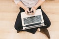 Top view man typing text message on his smart phone while sitting front open laptop computer, office man connecting to wireless v Royalty Free Stock Photo