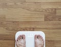 Top view, a man using body scale checking body weight, dieting and lose weight concept Royalty Free Stock Photo