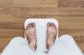 Top view, a man using body scale checking body weight, dieting and lose weight concept Royalty Free Stock Photo