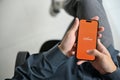 Top view of a man using Payoneer mobile application at his desk. International payments service