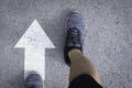 Top view of man wearing shoes choosing a way marked with white arrows. Chooses the right path concept Royalty Free Stock Photo