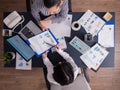 Top view of manager explaing financial strategy to employee sitting at desk