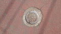 Top view of a manhole cover on drainage or sewerage under paved road Royalty Free Stock Photo