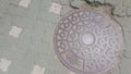 Top view of a manhole cover on drainage or sewerage under paved road Royalty Free Stock Photo