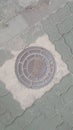 Top view of a manhole cover on drainage or sewerage under paved road Royalty Free Stock Photo