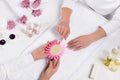 top view of manicurist holding samples of nail varnishes while woman