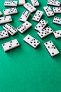 Top view of many domino pieces on green mat to play, vertically Royalty Free Stock Photo