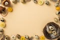 Top view of many eggs with brown spots cute feathers nest two small baskets and cute yellow beige and white flowers situated on Royalty Free Stock Photo