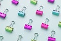 Top view of many multicolor binders clips on pastel blue background. Royalty Free Stock Photo