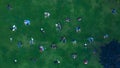 Top View Many people rest on a green lawn. Drone Photo 90 degrees. Social distance while relaxing on the lawn after